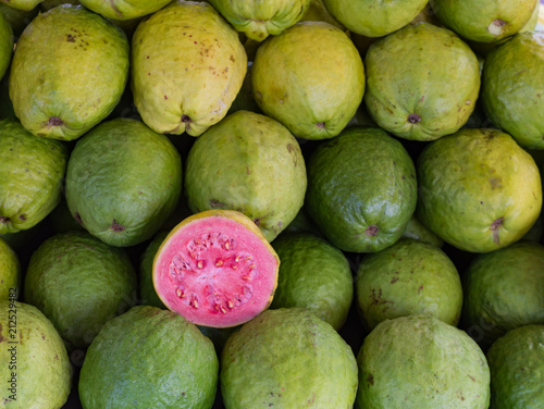 Green guava or pink guava showcase for sale at fair, fresh produce and rich in vitamin A.
