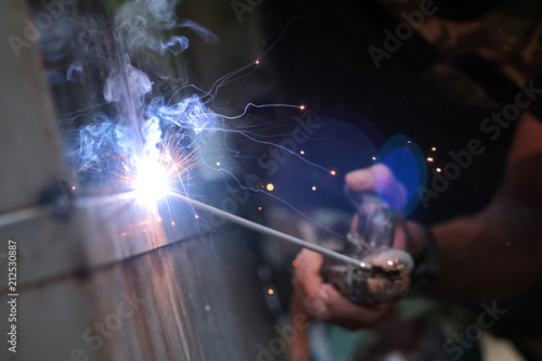 The reaction of welding wire and metal with smoke fire and sparkle light