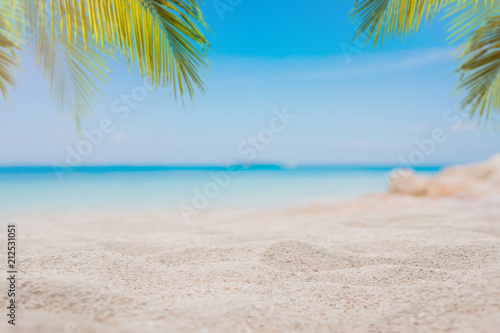 Fototapeta Naklejka Na Ścianę i Meble -  White sand on the beach with blurred sea and coconut tree background - can used for display or montage your products.