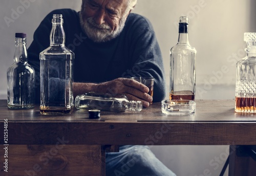 Elderly man drinking alcohol photo