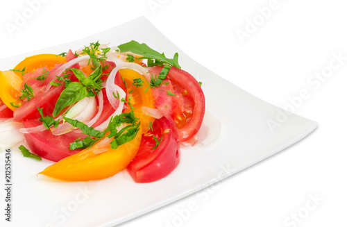 Salad of red and yellow tomatoes and onion close-up