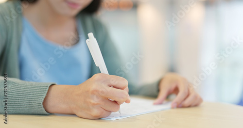 Student writing note at school