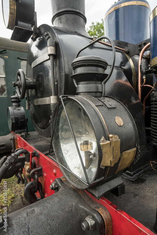 old steam train with a large oil lamp