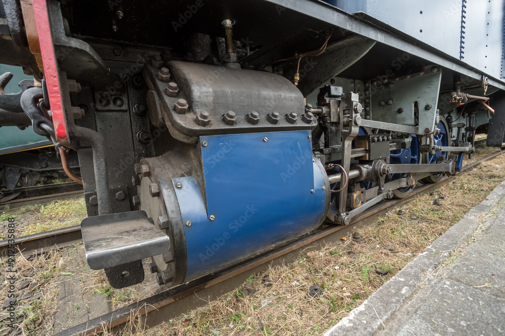 an iron wheel of a steam train an iron wheel of a steam train