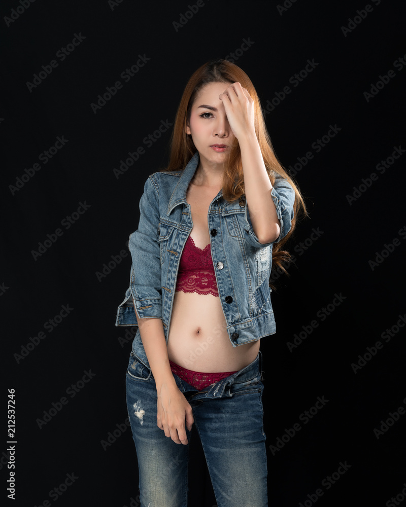 Asian girl in sexy jeans shows red lingerie on black background Stock Photo  | Adobe Stock