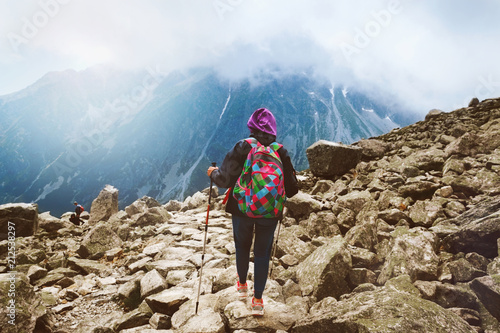 Woman traveler backpack tracking sticks top mountain Mount Rysy Tatras Slovakia