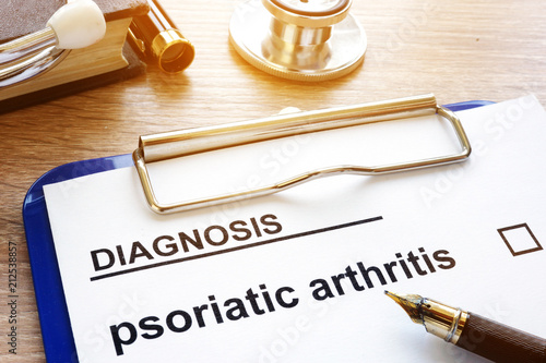 Diagnosis psoriatic arthritis and clipboard on a desk. photo