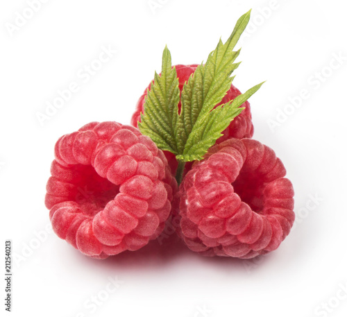 Group of fresh red raspberries with green leaves isolated on white background