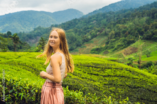 Women tourist at a tea plantation. Natural selected, Fresh tea leaves in tea farm in Cameron Highlands, Malaysia. Ecotourism concept photo