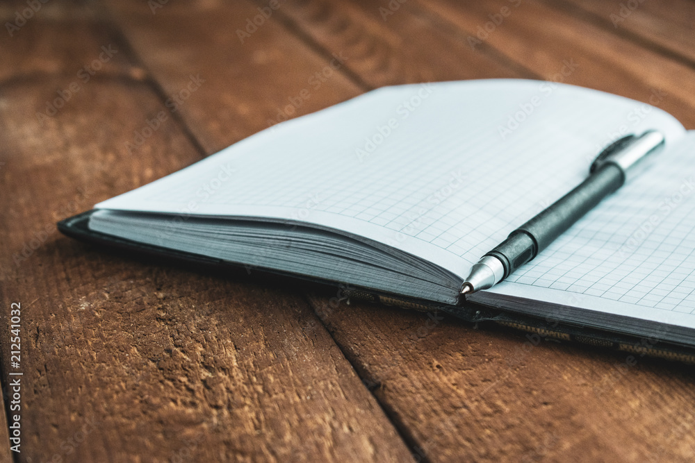 notebook with pen on old wooden table notebook with pen on old wooden table