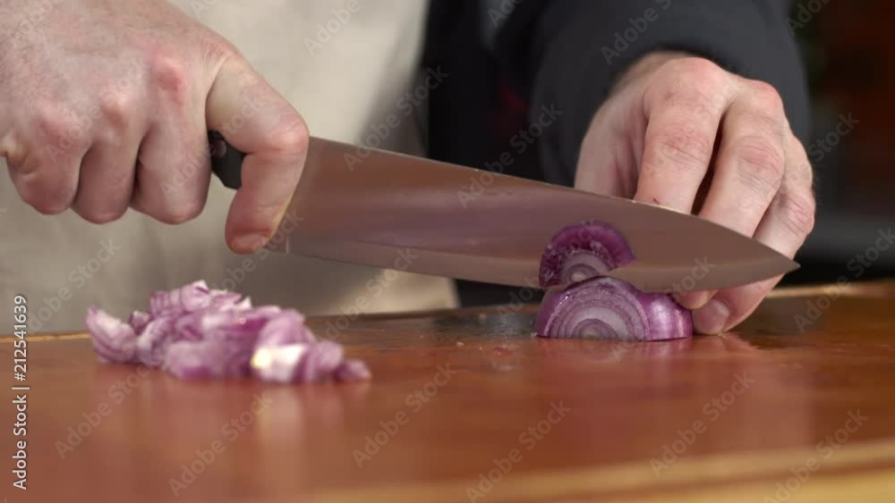 Tracking shot of chef slicing red onion Tracking shot of chef slicing red onion