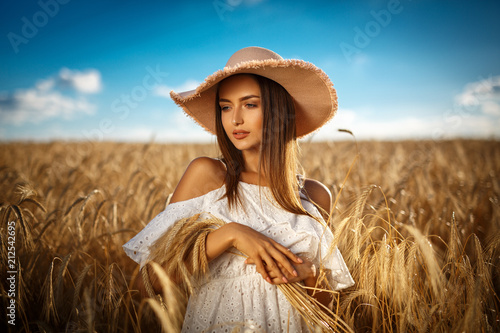 Beautiful blonde girl in a wheat field