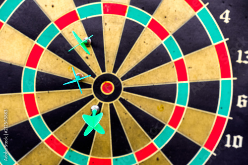 Three darts in side the target on aged dartboard