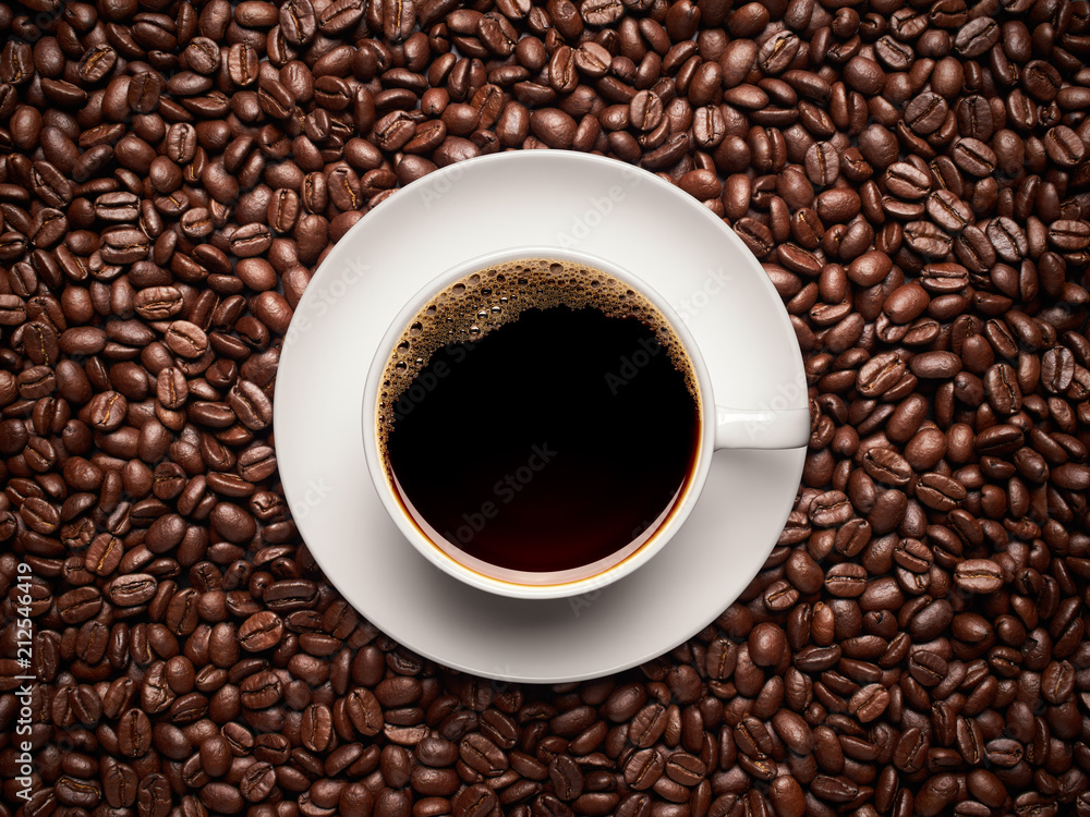 Cup of coffee on top of coffee beans Cup of coffee on top of coffee beans