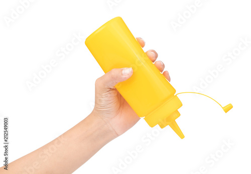 Fotografie hand holding bottle mustard isolated on white background