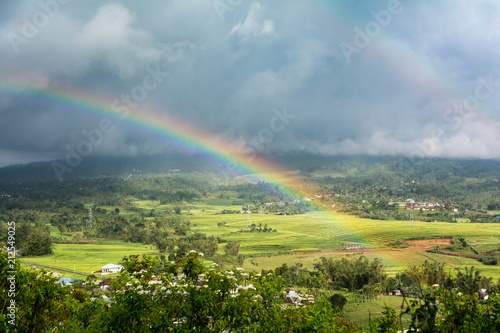 Double Rainbow Over Countryside with a Storm background. Ruteng, Manggarai Regency, Flores, East Nusa Tenggara, Indonesia photo