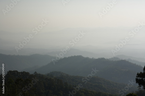 mountain ranges in Northern Thailand stretching into the distance covered in fog and smoke, Southeast Asia