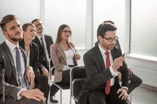 Manager asks a question at a business meeting