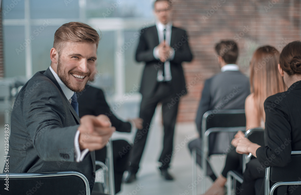 Fototapeta premium businessman sitting in the conference room, pointing at you