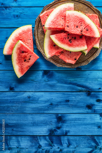 Top of view pieces of fresh watermelon on blue table