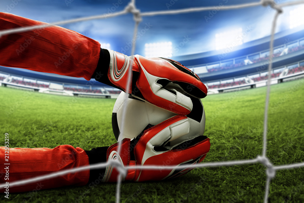 Naklejka premium Soccer goalkeeper catches the ball