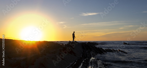 Girl on the beach with the sun and the sea in the background, Sakoneta beach, Euskadi