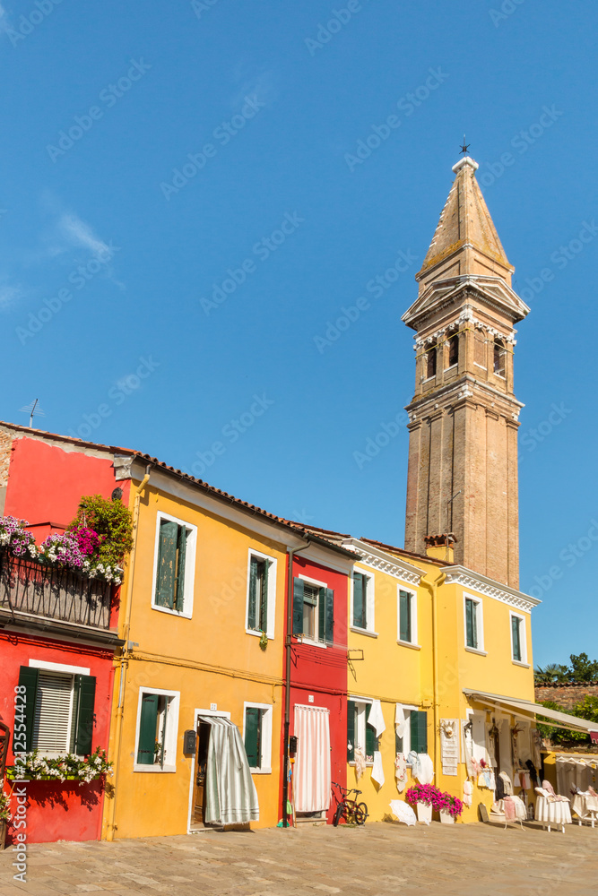 colourful houses with leaning tower of San Martino church in Burano, Italy