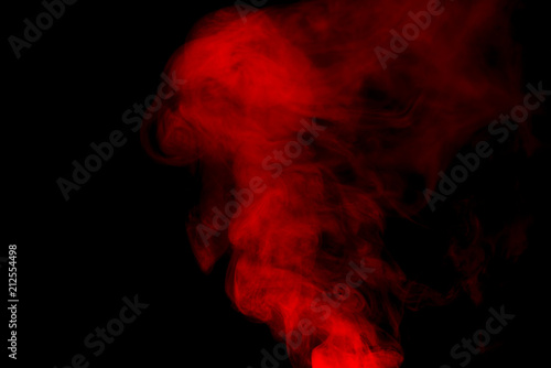 Red smoke isolated on black background.