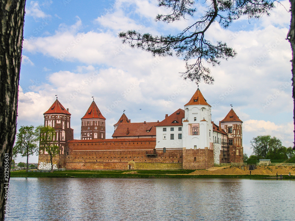 Mir, Belarus. Castle Complex Mir On Sunny Day with blue sky Background. Old medieval Towers and walls of traditional fort from unesco world heritage list Mir, Belarus. Castle Complex Mir On Sunny Day with blue sky Background. Old medieval Towers and walls of traditional fort from unesco world heritage list