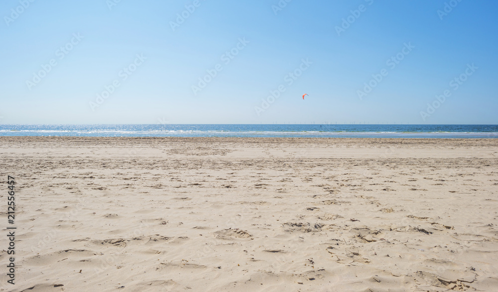 Kitesurfing on sea along the beach in sunlight in summer Kitesurfing on sea along the beach in sunlight in summer
