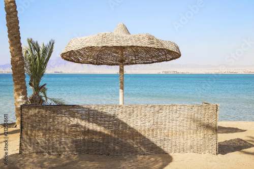 Straw umbrella on tropical beach