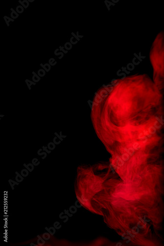 Red smoke isolated on black background. © joesayhello