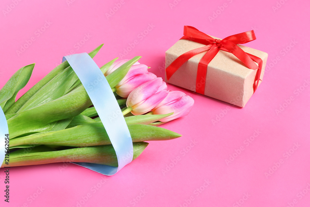 tulips with a gift on a pink background tulips with a gift on a pink background