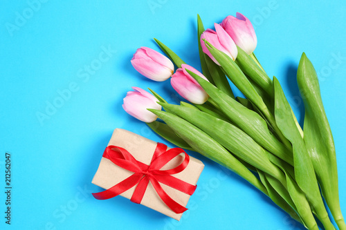 tulips with a gift on a blue background