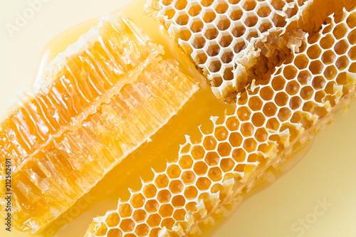 Piece of honeycomb with honey in closeup, healthy products by organic ingredients