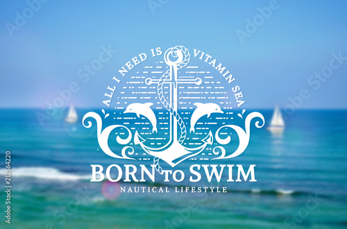 Sea emblem with anchor and dolphins on blurred background.