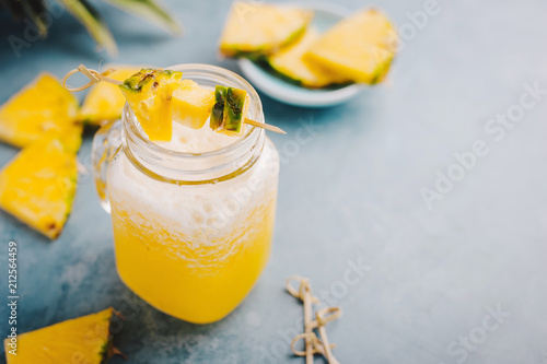 Sweet pineapple drink cocktail on blue