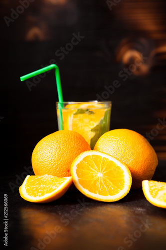 Fresh organic orangeade made of natural fruits on vintage wooden background
