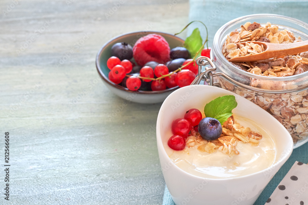 Yogurt with muesli and berries, healthy dessert on neutral background Yogurt with muesli and berries, healthy dessert on neutral background