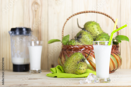 Soursop juice and soursop fruit or Prickly Custard Apple or Annona muricata L on wooden table.