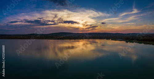 Fototapeta Naklejka Na Ścianę i Meble -  Balatonfuzfo, Hungary - Beautiful panoramic sunset with reflection at Fuzfoi-obol taken above Lake Balaton