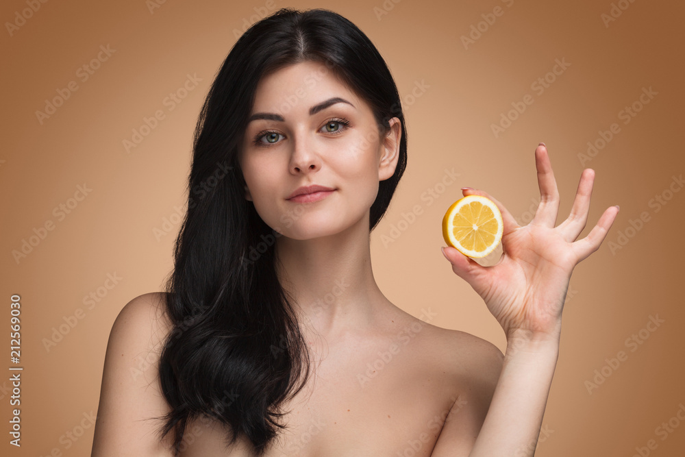 Sensual naked woman with half of orange Sensual naked woman with half of orange