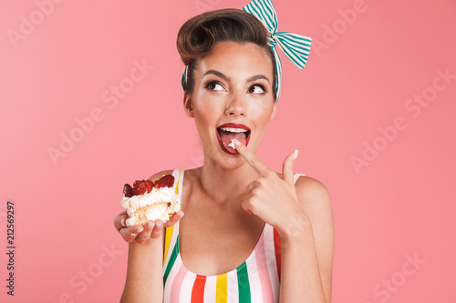 Beautiful pin up woman isolated holding cake.