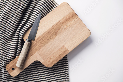 Wooden chopping board and knife with a striped cloth