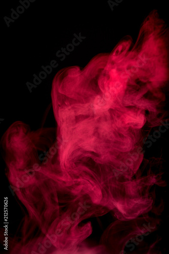 Red smoke isolated on black background.