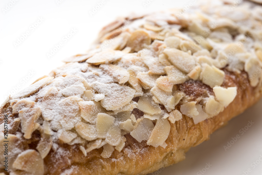 Almond croissant filled with almond cream and topped with sliced almonds Almond croissant filled with almond cream and topped with sliced almonds
