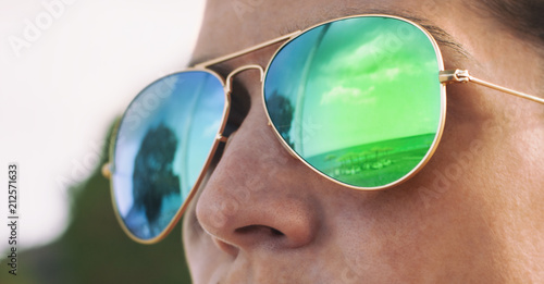 Girl with pilot sunglasses on the beach with reflection, panorama photo