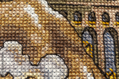 Cross-stitch. Macro photography of embroidery sites. Shooting with a small bluff of sharpness.
