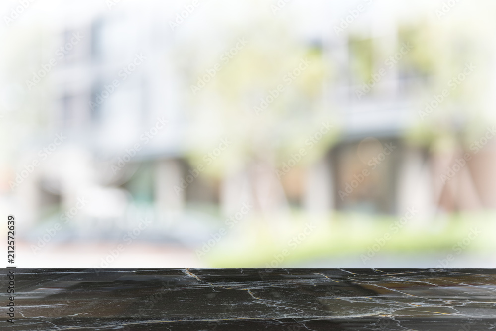 black marble table top on blur coffee shop window background black marble table top on blur coffee shop window background