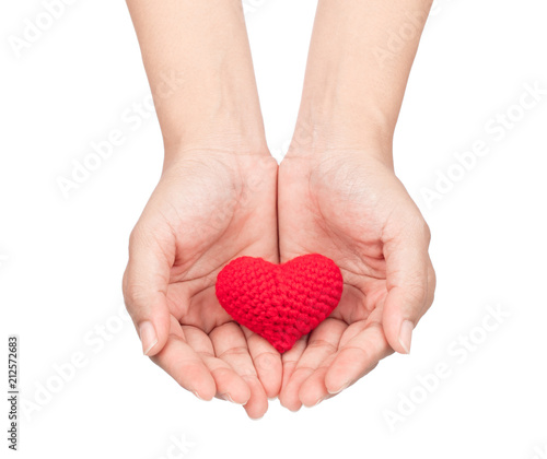 hands holding red crocheted heart isolated on white background